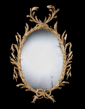 A GEORGE II GILTWOOD OVAL MIRROR ATTRIBUTED TO JOHN LINNELL