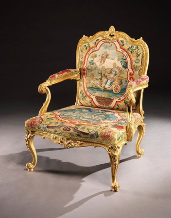 A GEORGE II GILTWOOD OPEN ARMCHAIR ATTRIBUTED TO MAYHEW & INCE