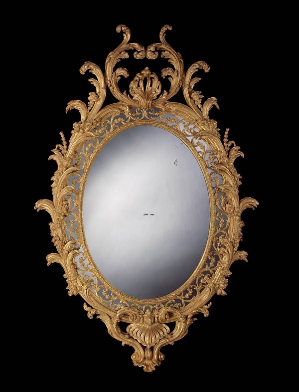 A MAGNIFICENT PAIR OF GEORGE III CARVED GILTWOOD OVAL MIRRORS