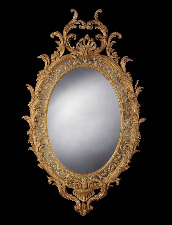 A MAGNIFICENT PAIR OF GEORGE III CARVED GILTWOOD OVAL MIRRORS