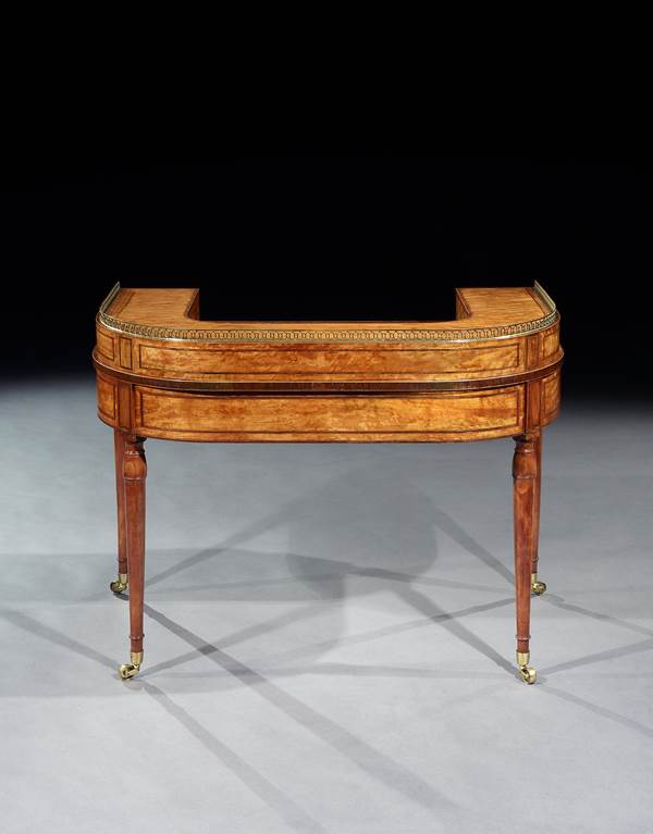 A GEORGE III SATINWOOD CARLTON HOUSE WRITING TABLE ATTRIBUTED TO GILLOWS