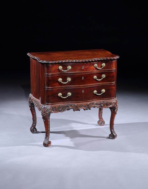 A PAIR OF GEORGE II SERPENTINE MAHOGANY COMMODE CHESTS ON STANDS