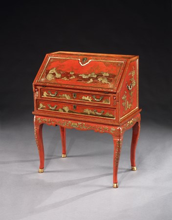 A GEORGE II PERIOD CHINESE RED LACQUER BUREAU ON STAND