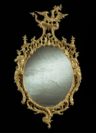 A GEORGE III GILTWOOD MIRROR TO A DESIGN BY THOMAS JOHNSON AND ATTRIBUTED TO THOMAS JOHNSON