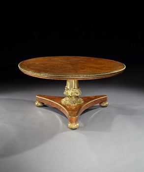 A GEORGE IV BRASS MOUNTED PARCEL GILT AMBOYNA CENTRE TABLE BY WILLIAM RIDDLE

