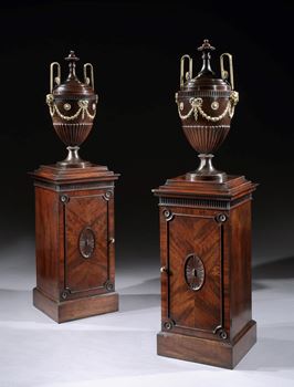 A PAIR OF GEORGE III URNS ON PEDESTALS PROBABLY BY THOMAS CHIPPENDALE