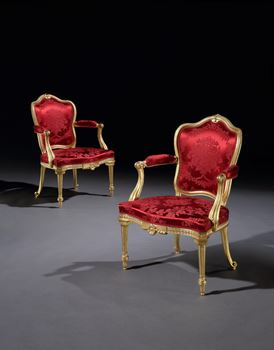 A PAIR OF GEORGE III GILTWOOD ARMCHAIRS ALMOST CERTAINLY BY THOMAS CHIPPENDALE