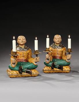 A PAIR OF REGENCY POLYCHROME DECORATED CAST METAL SEATED NODDING HEAD CHINAMEN CANDELABRA