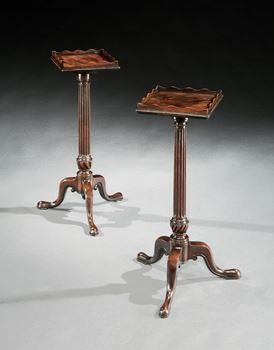 A NEAR PAIR OF GEORGE III MAHOGANY URN STANDS