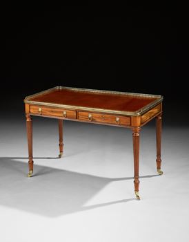 A REGENCY BRASS MOUNTED MAHOGANY WRITING TABLE ATTRIBUTED TO GILLOWS