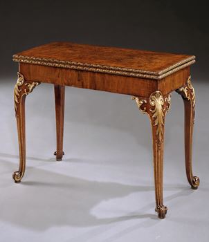 A GEORGE II WALNUT AND PARCEL GILT CARD TABLE ATTRIBUTED TO PAUL SAUNDERS