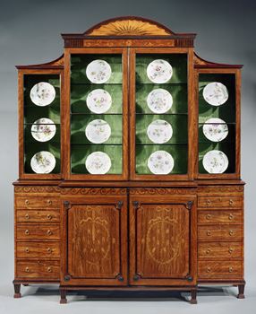 AN IMPORTANT GEORGE III INLAID BREAKFRONT BOOKCASE ATTRIBUTED TO MAYHEW AND INCE