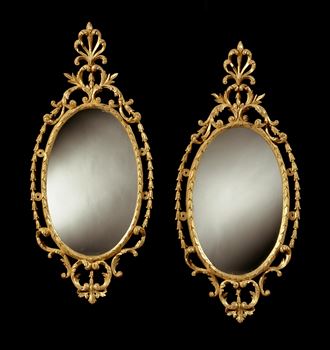 A PAIR OF GEORGE III OVAL GILTWOOD MIRRORS