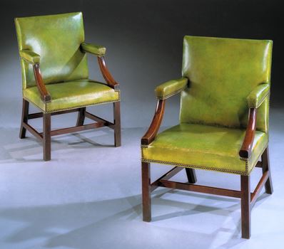 A PAIR OF GEORGE III MAHOGANY LIBRARY ARMCHAIRS